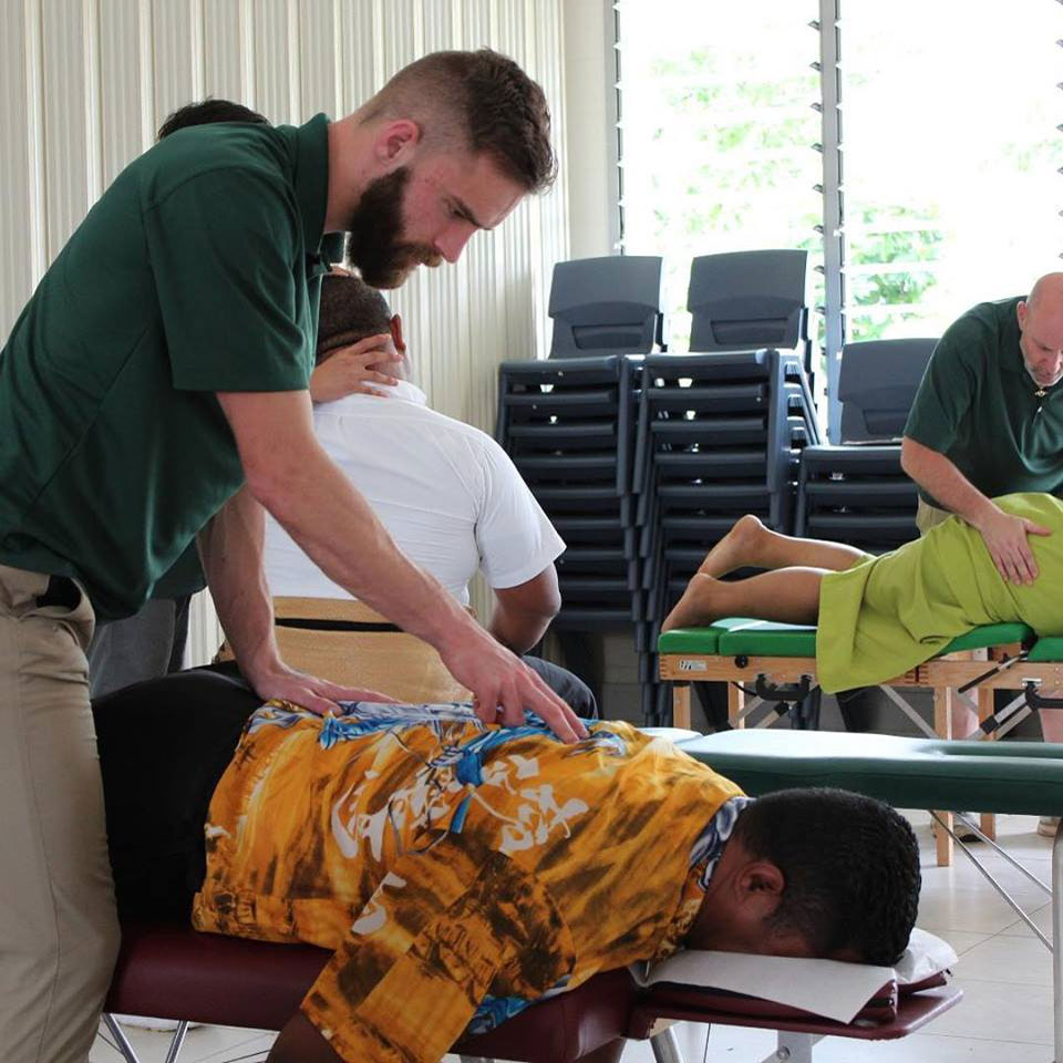 LIfe West students participating in a service trip in Tonga offering chiropractic care