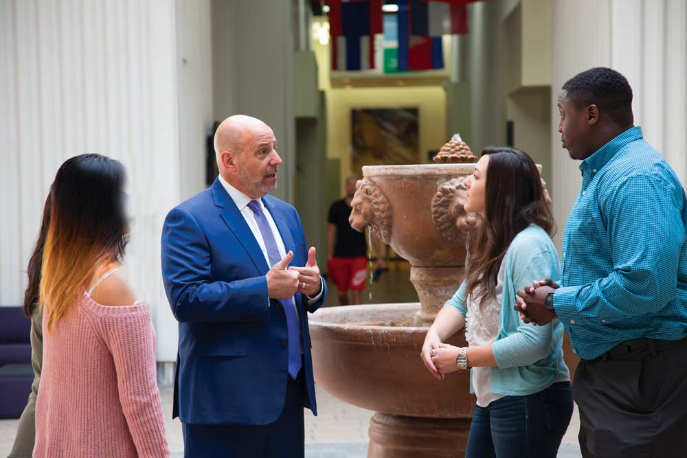 Life West President, Dr. Ron Oberstein, talking with chiropractic students on campus