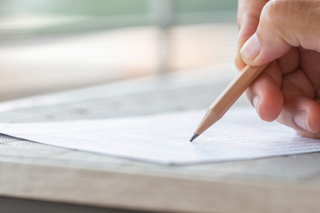 Student taking multiple choice exam representing the NBCE chiropractic board exam