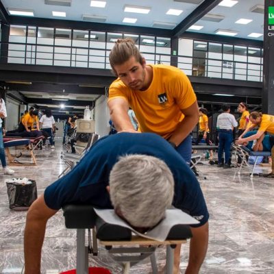 Life West Chiropractic student adjusting a patient on a service trip in Mexico City